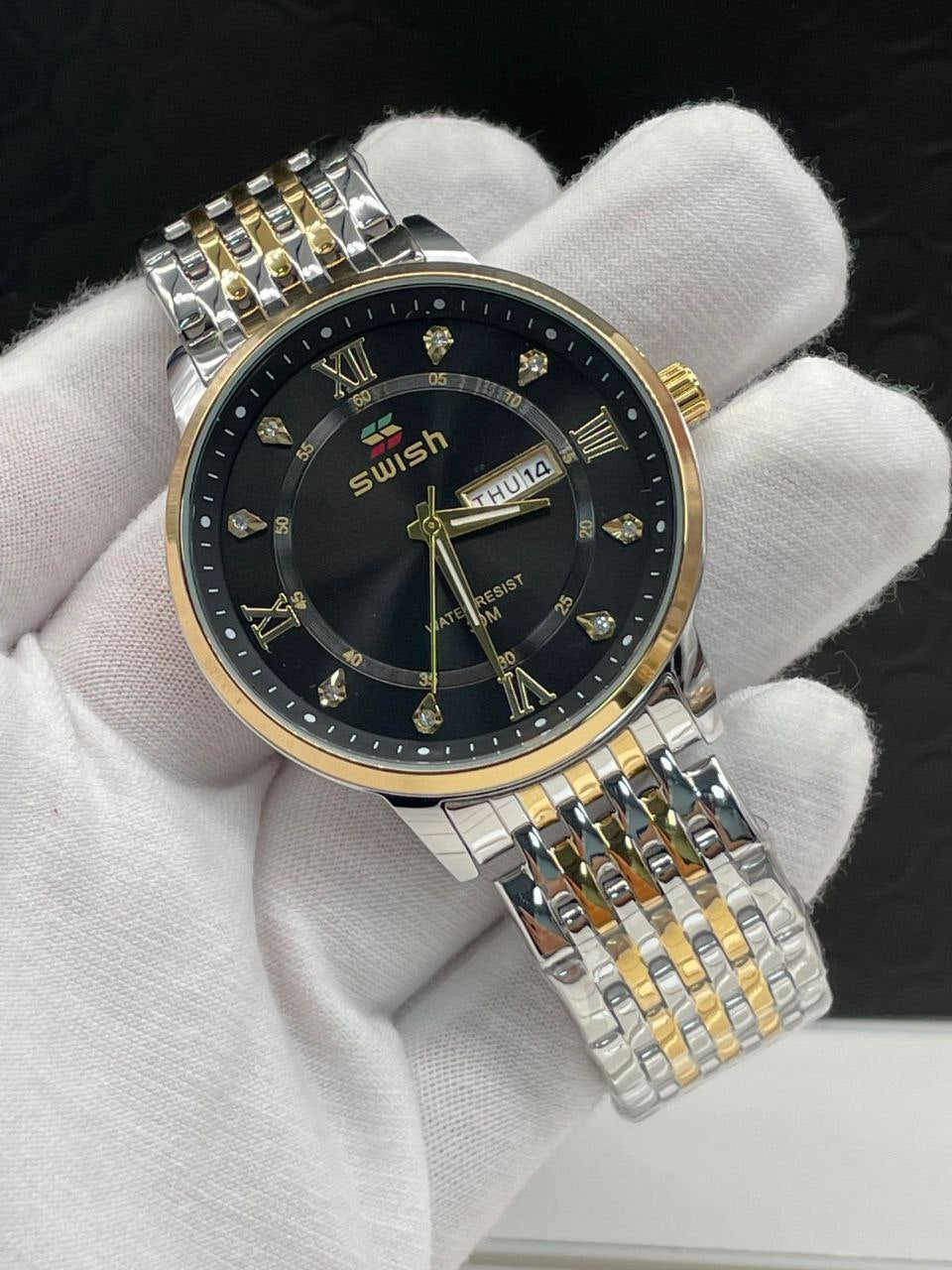 SWISH GENTS WATCH DAY&DATE DISPLAY BATTERY POWERED STAINLESS STEEL WATER RESISTANT TWO-TONE GOLDSILVER ENQUIRIES